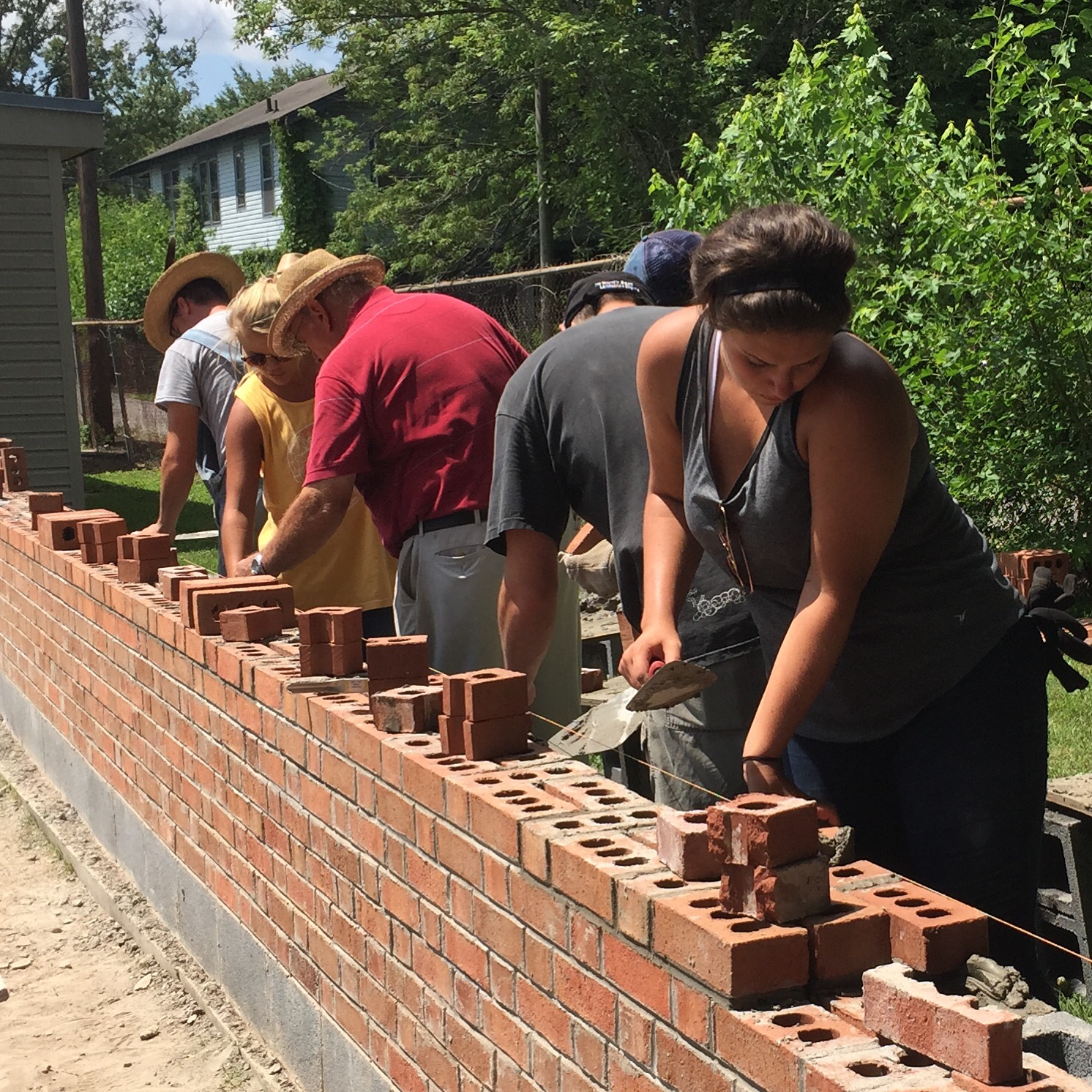 A group lays bricks.