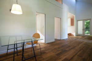 An interior photo of the New Norris House showing a wooden floor and the 