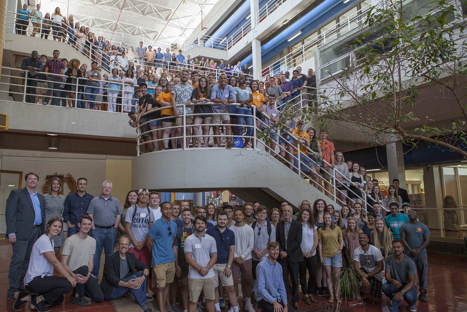 A picture of the college's faculty and students on the stairs in the Art + Architecture building.