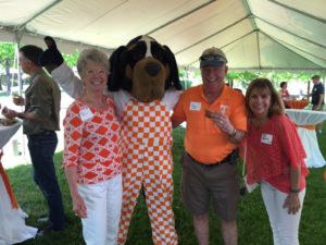 The Mascot Smokey with alumni at a tailgate party