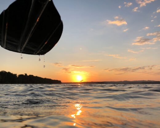 Paddle with drips of water and sunset